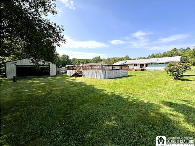 view of yard featuring a deck and an outbuilding