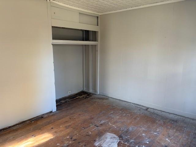 unfurnished bedroom featuring wood-type flooring and an ornate ceiling