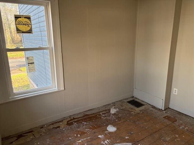 spare room featuring baseboards and visible vents