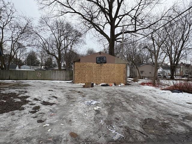 exterior space with an outdoor structure, fence, and a residential view