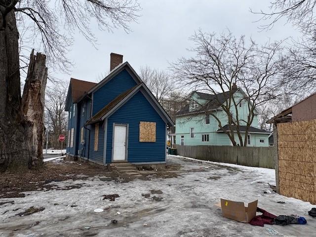 exterior space with entry steps, fence, and a chimney