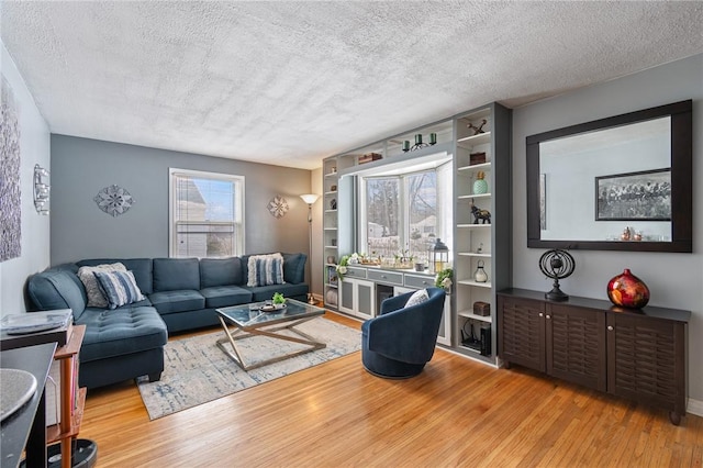 living area featuring a textured ceiling and light wood-style floors