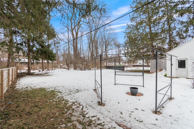 yard covered in snow with fence