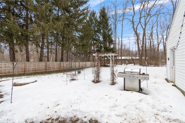 snowy yard with fence