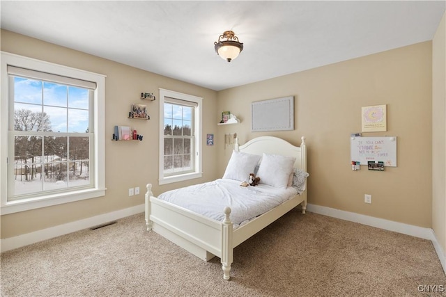 bedroom with baseboards, visible vents, and carpet flooring