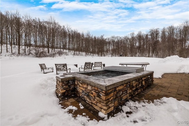 snow covered deck featuring a fire pit