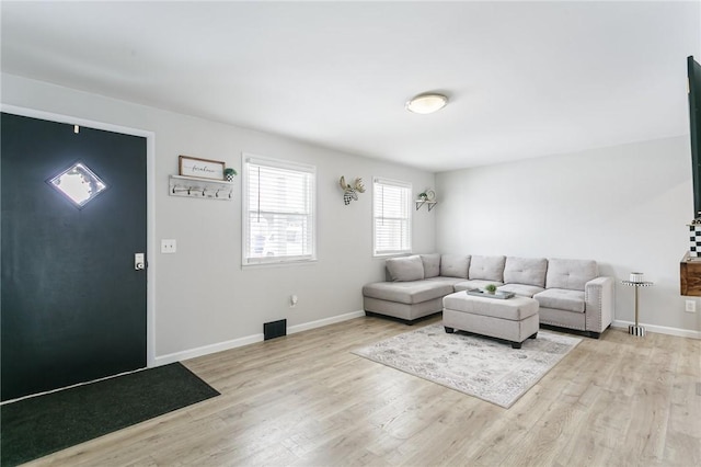 living area featuring wood finished floors and baseboards