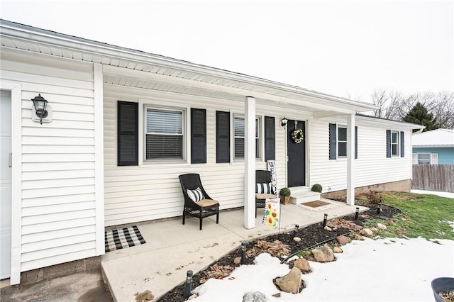 exterior space with a porch and fence