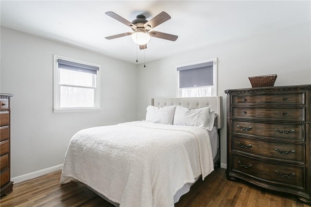 bedroom featuring dark wood-type flooring, a ceiling fan, and baseboards