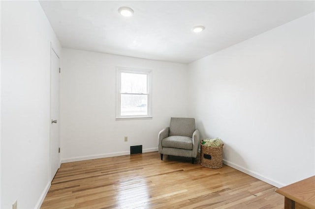 unfurnished room with visible vents, light wood-style flooring, and baseboards