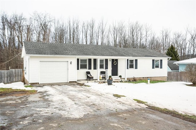 ranch-style house with a garage, entry steps, fence, and driveway