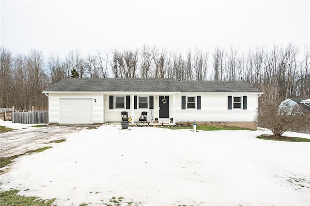 ranch-style house featuring an attached garage, driveway, and fence