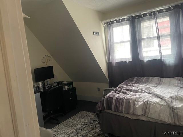 bedroom with lofted ceiling