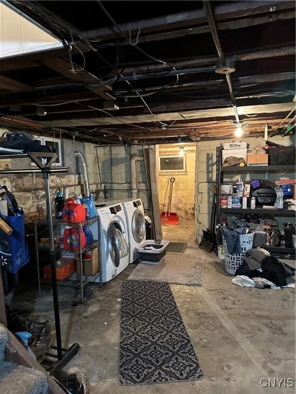 unfinished basement featuring independent washer and dryer