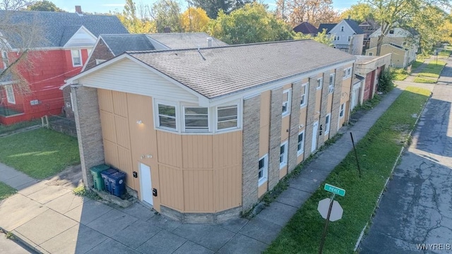 exterior space featuring a shingled roof