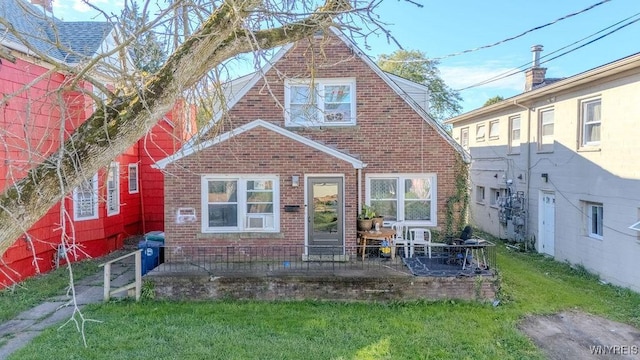 view of front of home featuring a front yard and brick siding