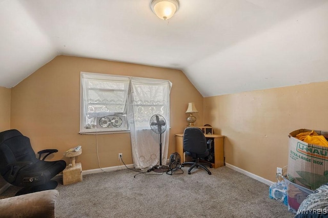 carpeted home office with vaulted ceiling and baseboards