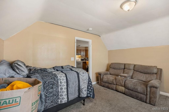 carpeted bedroom with lofted ceiling and baseboards