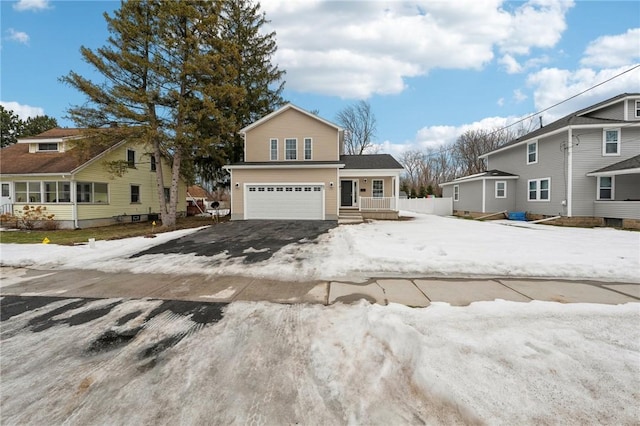 traditional-style home with driveway and an attached garage