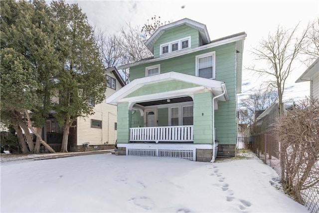 american foursquare style home with covered porch