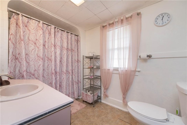 full bath with baseboards, vanity, and toilet