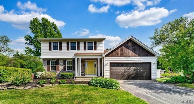 view of front of home featuring a garage, a front yard, and concrete driveway