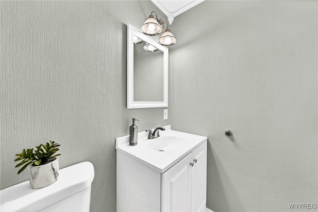 bathroom featuring toilet and vanity