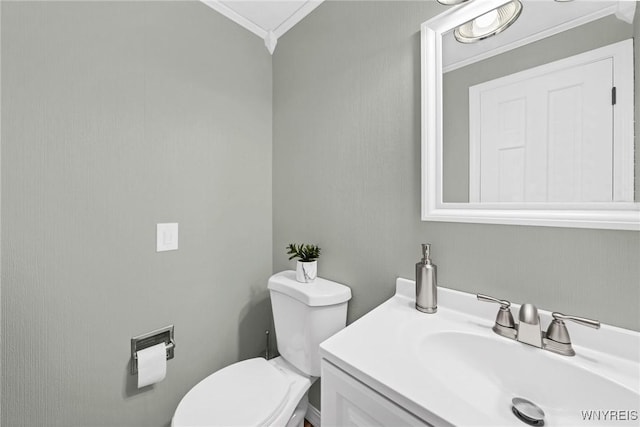 bathroom featuring vanity, toilet, and crown molding