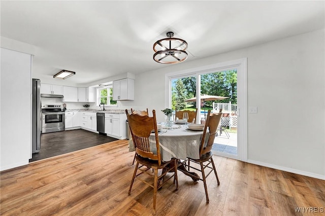 dining room with dark wood finished floors and baseboards