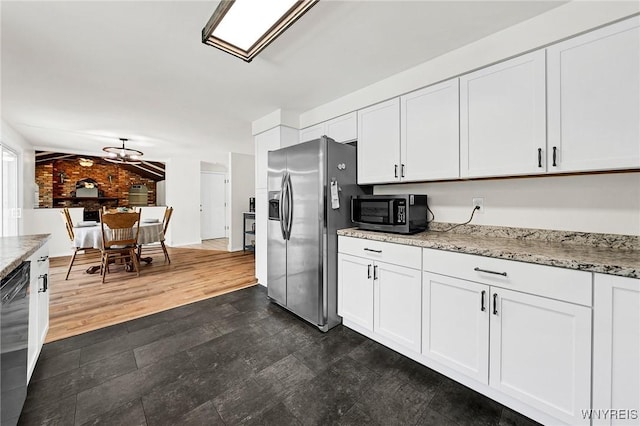 kitchen featuring dark wood-style flooring, white cabinetry, stainless steel appliances, and light stone counters