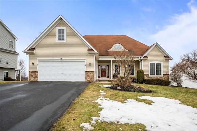 view of front of house with driveway and stone siding