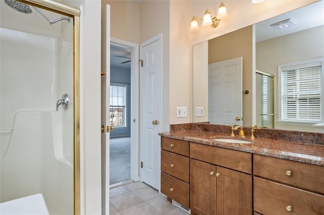 bathroom with a shower stall, visible vents, tile patterned flooring, and vanity