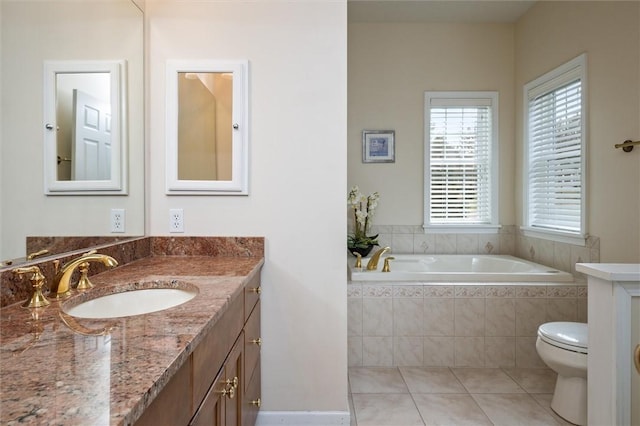 bathroom featuring toilet, a garden tub, tile patterned flooring, and vanity