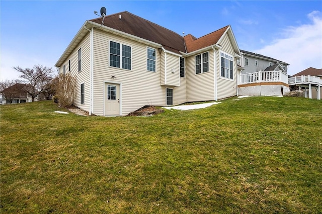 back of house featuring a deck and a yard