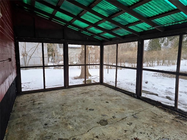 unfurnished sunroom featuring lofted ceiling