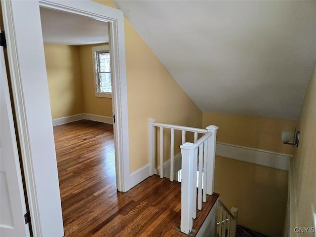 additional living space with lofted ceiling, wood finished floors, and baseboards