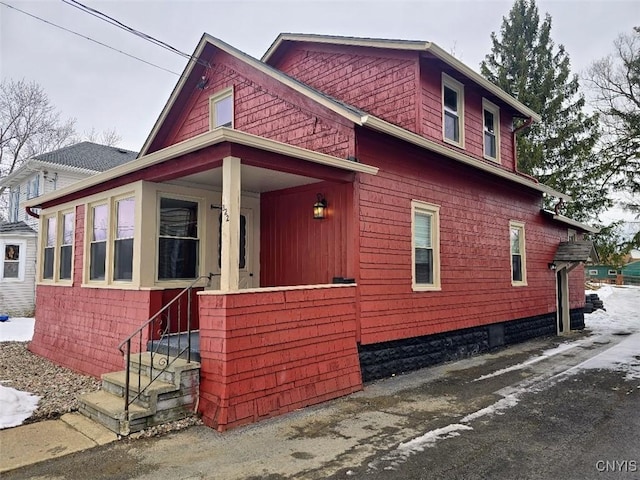 view of side of home featuring a porch