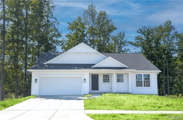 view of front facade featuring concrete driveway, a garage, and a front lawn