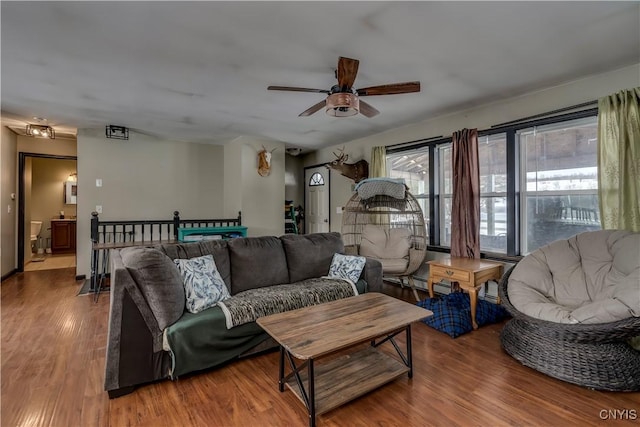 living room with ceiling fan and wood finished floors