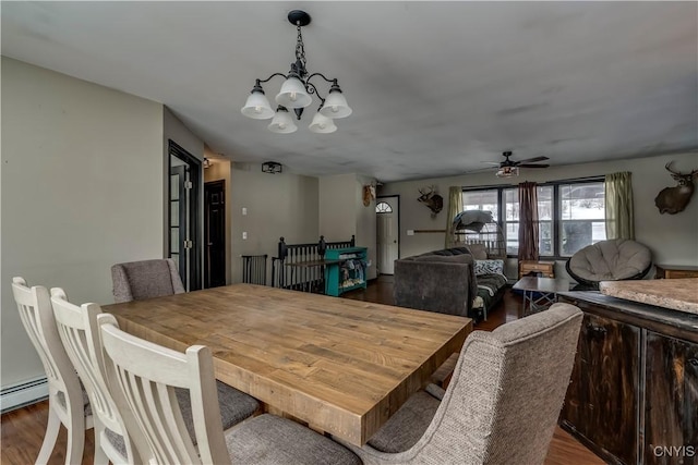 dining area with a baseboard radiator, dark wood finished floors, and a notable chandelier