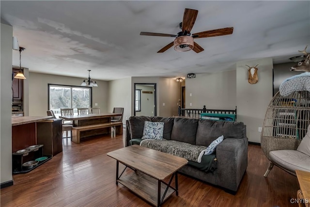 living room featuring ceiling fan and dark wood finished floors