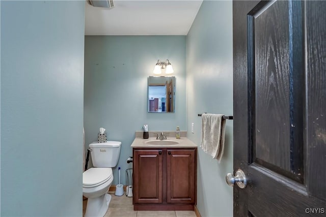 half bath with vanity, tile patterned flooring, and toilet