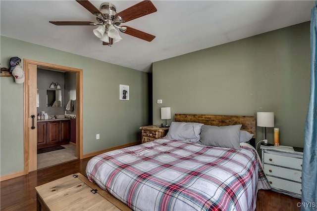 bedroom with ceiling fan, ensuite bath, wood finished floors, and baseboards