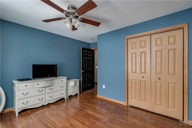 bedroom with ceiling fan, a closet, baseboards, and wood finished floors