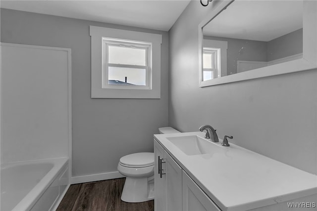 full bathroom featuring baseboards, vanity, toilet, and wood finished floors