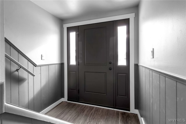 foyer featuring wood finished floors and wainscoting