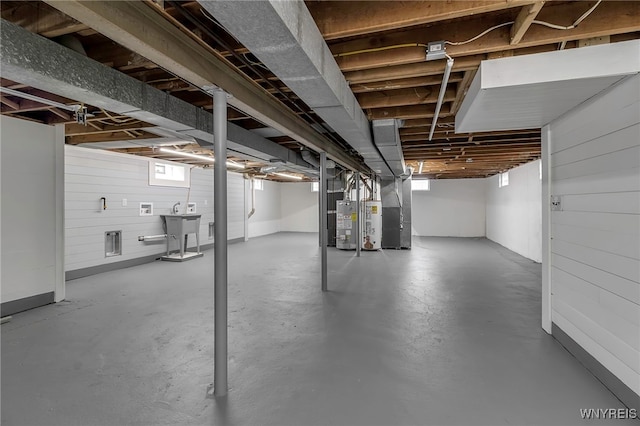 basement featuring water heater and heating unit