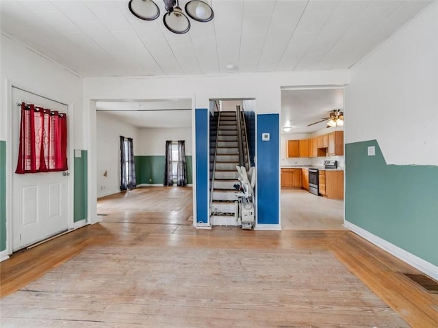 entrance foyer featuring stairs, visible vents, light wood-style flooring, and baseboards