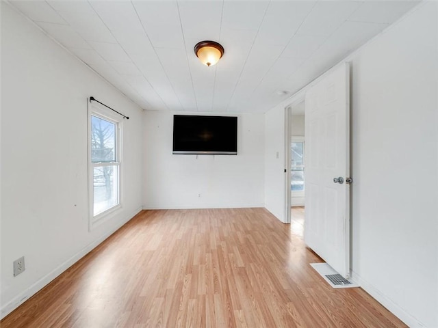 unfurnished room featuring light wood-type flooring and baseboards