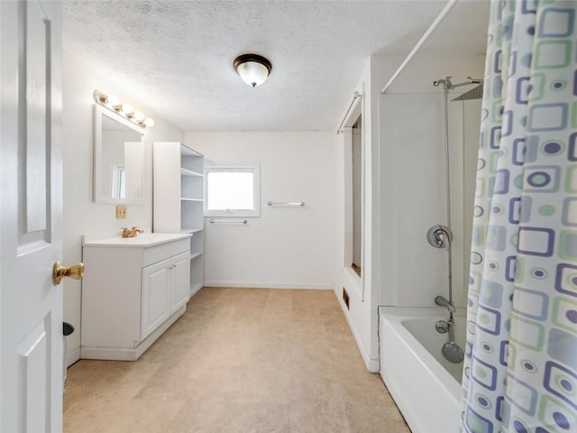 bathroom with baseboards, shower / tub combo with curtain, vanity, and a textured ceiling